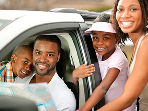 Black family getting into a car