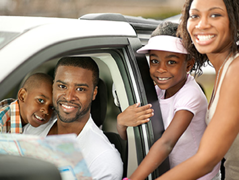 Black family getting into a car