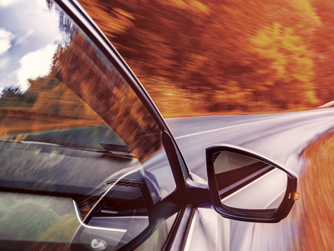 Close up of car driving along a road