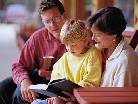 Mom and dad reading to their son