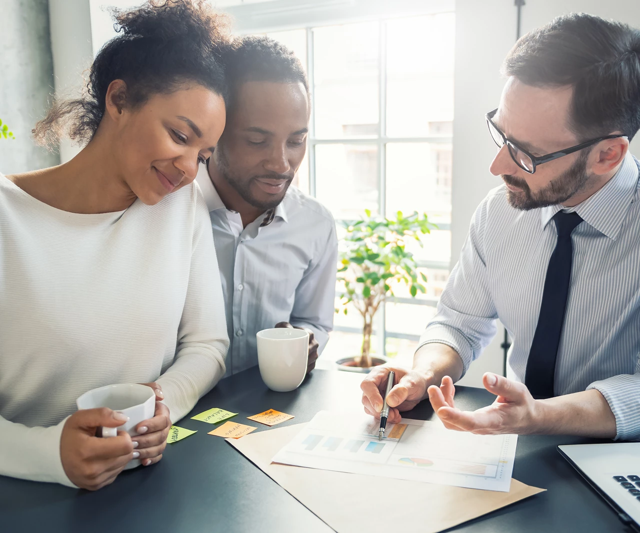 Couple reviewing documents with advisor