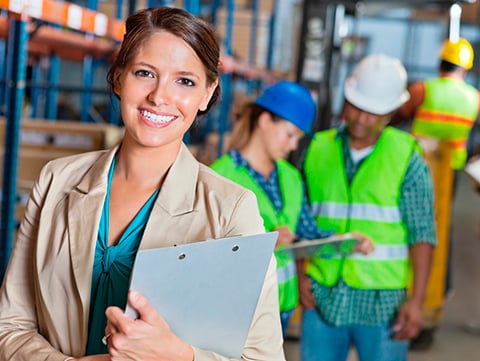 Woman holding a clipboard in a warehouse